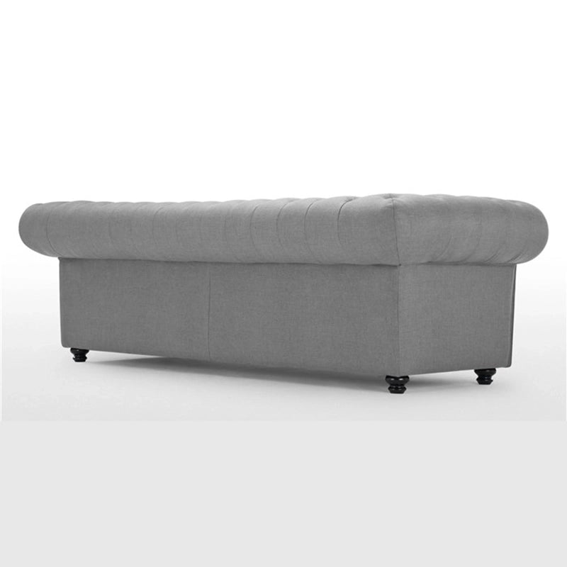 The turned wooden legs lend a grounded feel, enhancing its settee-like proportions.