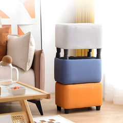 ts tufted faux leather surface sits atop a compact base, creating a comfortable seat or footrest for modern homes.