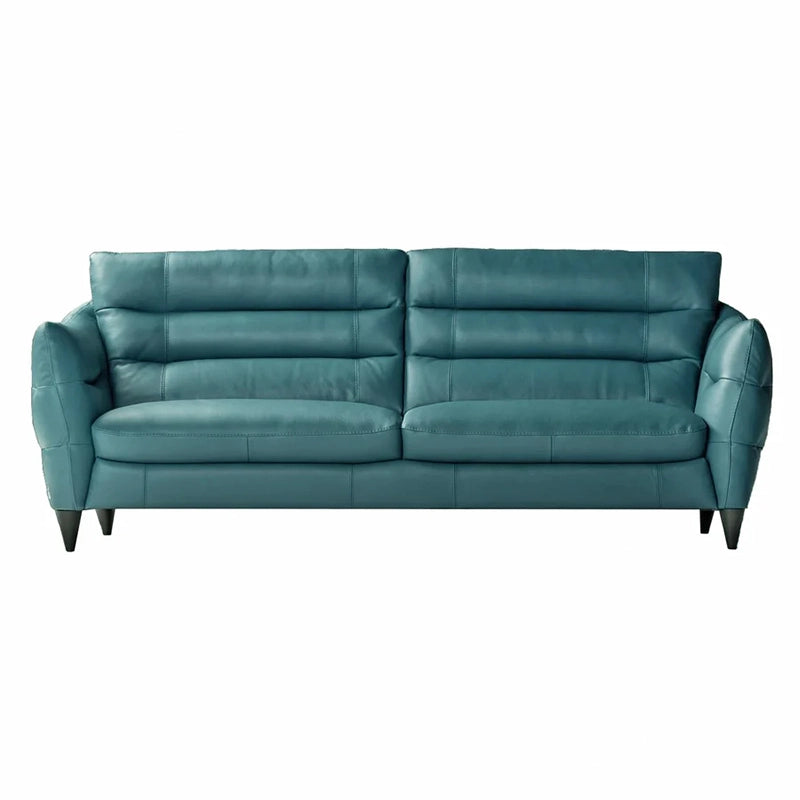 The modern silhouette, paired with tapered legs and ergonomic cushioning, makes it a standout choice for refined interiors.