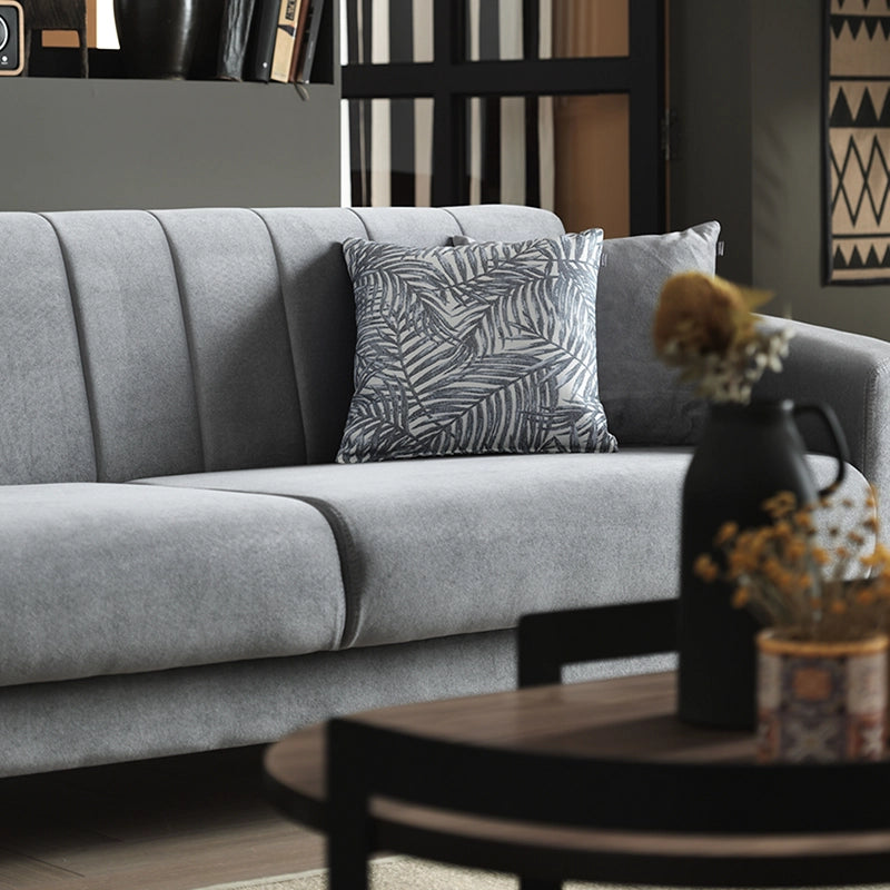 Gray sofa with decorative pillows in a living room setting