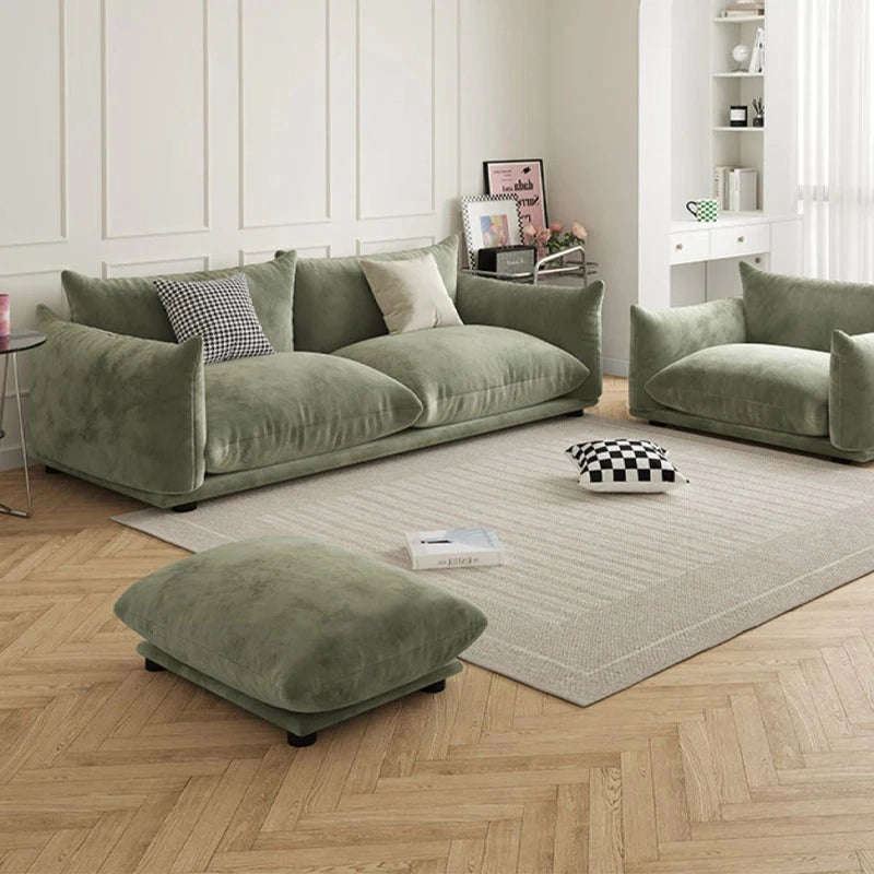 This contemporary settee in sage green blends low-profile style with deep lounge seating and modular symmetry.