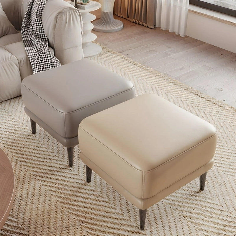 Upholstered in smooth faux leather with a matte finish, it suits neutral palettes ranging from taupe to grey.