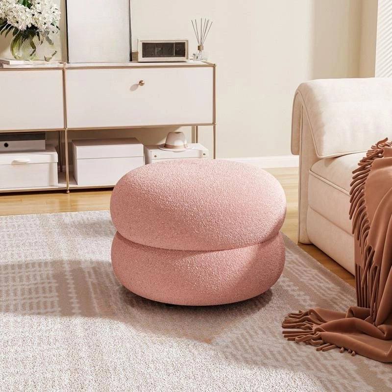 Pink boucle texture pouffe pic footstool and pouffe chair, plush finish and compact shape.