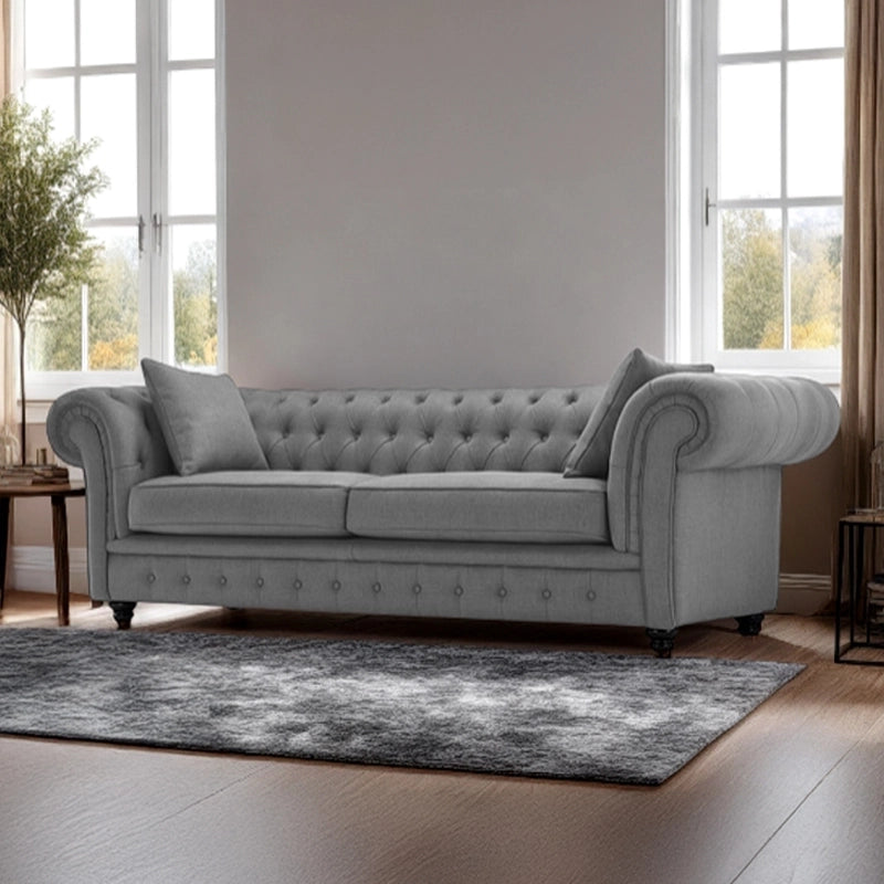 Crafted as a 3 seater couch, it features deep button tufting across the backrest and front base, rolled arms, and a linear silhouette that fits beautifully in formal lounges or modern Indian living rooms.
